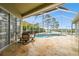 Screened patio with a dining set overlooking a pool and scenic waterfront view at 1204 Blackrush Dr, Tarpon Springs, FL 34689