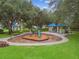 This Gathering-friendly playground features multiple green slides and picnic tables in a shaded park at 1204 Blackrush Dr, Tarpon Springs, FL 34689