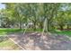 This community park features a swing set, green slide, and shaded picnic area among mature trees at 1204 Blackrush Dr, Tarpon Springs, FL 34689