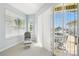 Bright sitting area with chair, windows, and sliding doors to the lanai and pool at 1204 Blackrush Dr, Tarpon Springs, FL 34689