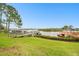 Picturesque waterfront view showcasing a private wooden dock and lush landscaping at 1204 Blackrush Dr, Tarpon Springs, FL 34689