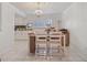 Open dining area adjacent to the updated kitchen, with an elegant chandelier at 1381 Amberlea E Dr, Dunedin, FL 34698