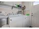 This laundry room features a washer, dryer, and shelf for storage at 1381 Amberlea E Dr, Dunedin, FL 34698