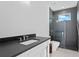 Modern bathroom boasts gray tile, a glass-enclosed shower, and sleek fixtures at 1401 Brightwaters Ne Blvd, St Petersburg, FL 33704
