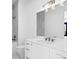 Elegant bathroom featuring white marble countertops, modern vanity and a large mirror with vanity lighting at 1401 Brightwaters Ne Blvd, St Petersburg, FL 33704