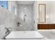 Elegant bathroom featuring a soaking tub, walk-in shower, marble tile, and double vanity at 1401 Brightwaters Ne Blvd, St Petersburg, FL 33704