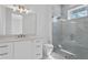 Modern bathroom with glass-enclosed shower, marble accents, sleek fixtures and a modern vanity at 1401 Brightwaters Ne Blvd, St Petersburg, FL 33704