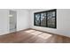 Well-lit bedroom with hardwood floors, window views and an attached bathroom for added convenience at 1401 Brightwaters Ne Blvd, St Petersburg, FL 33704
