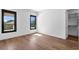Bright bedroom featuring hardwood floors, modern windows, and a walk-in closet for ample storage at 1401 Brightwaters Ne Blvd, St Petersburg, FL 33704