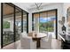 Bright dining room with floor to ceiling windows, seating four, with a view of the pool area at 1401 Brightwaters Ne Blvd, St Petersburg, FL 33704