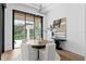 Cozy dining area with a round table, modern lighting, and serene outdoor views at 1401 Brightwaters Ne Blvd, St Petersburg, FL 33704