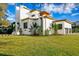 Modern home with a manicured lawn, contemporary design, and bright exterior paint at 1401 Brightwaters Ne Blvd, St Petersburg, FL 33704