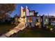 Elegant modern home with beautiful landscaping and inviting entrance under the glow of evening at 1401 Brightwaters Ne Blvd, St Petersburg, FL 33704