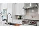 A close-up view of the stove and countertops in a kitchen with white cabinetry at 1401 Brightwaters Ne Blvd, St Petersburg, FL 33704