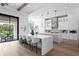 Open kitchen with an island, seating, stainless appliances, and sliding doors to the outdoor pool at 1401 Brightwaters Ne Blvd, St Petersburg, FL 33704