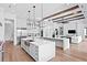 Open-concept kitchen featuring dual islands, stainless steel appliances, and designer finishes at 1401 Brightwaters Ne Blvd, St Petersburg, FL 33704
