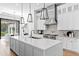 Bright kitchen showcasing a large center island, pendant lighting, and stainless steel appliances at 1401 Brightwaters Ne Blvd, St Petersburg, FL 33704