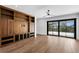 Spacious living room with hardwood floors, custom built-in shelving and access to an outdoor balcony at 1401 Brightwaters Ne Blvd, St Petersburg, FL 33704