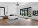 Bright, spacious main bedroom featuring a king bed, sitting area, and large windows with a view at 1401 Brightwaters Ne Blvd, St Petersburg, FL 33704
