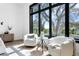 Bright sitting area near a large window with two white chairs and a round table, with natural light and great views at 1401 Brightwaters Ne Blvd, St Petersburg, FL 33704