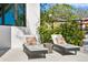 Comfortable lounge chairs offer relaxation and privacy on a serene patio at 1401 Brightwaters Ne Blvd, St Petersburg, FL 33704