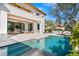 Inviting pool area with a spa, lounge chairs, and a covered patio for relaxing by the water at 1401 Brightwaters Ne Blvd, St Petersburg, FL 33704