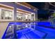 The backyard of this stunning house includes a luxurious pool, patio, and outdoor living area at 1401 Brightwaters Ne Blvd, St Petersburg, FL 33704