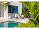Lounge by the shimmering pool with privacy, comfort, and tropical views at 1401 Brightwaters Ne Blvd, St Petersburg, FL 33704