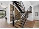 Modern staircase featuring wood stairs, black metal railings, and a wine storage wall at 1401 Brightwaters Ne Blvd, St Petersburg, FL 33704