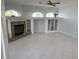 Cozy living room featuring tile floors, fireplace with a granite surround, and built-in shelving at 1423 Jumana Loop, Apollo Beach, FL 33572