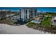 Beautiful aerial view of beachfront condo complex with pool, beach access and palm trees at 1460 Gulf Blvd # 506, Clearwater Beach, FL 33767