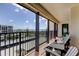 Balcony with black railings, water views, and patio furniture overlooking parking at 1460 Gulf Blvd # 506, Clearwater Beach, FL 33767