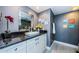 Bathroom featuring a granite vanity, modern sink, large mirror, and tiled shower with glass door at 1460 Gulf Blvd # 506, Clearwater Beach, FL 33767
