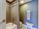 Bathroom featuring a tiled shower over a tub and light blue accent towels at 1460 Gulf Blvd # 506, Clearwater Beach, FL 33767