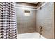 Bathroom featuring a tiled shower with a white and blue striped shower curtain at 1460 Gulf Blvd # 506, Clearwater Beach, FL 33767
