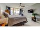 Bright bedroom with a ceiling fan, wood floors, and sliding glass doors to a balcony with an ocean view at 1460 Gulf Blvd # 506, Clearwater Beach, FL 33767