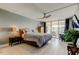 Bright bedroom with a ceiling fan, wood floors, and sliding glass doors to a balcony with an ocean view at 1460 Gulf Blvd # 506, Clearwater Beach, FL 33767