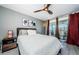 Bright bedroom with a ceiling fan and a sliding glass door to the balcony at 1460 Gulf Blvd # 506, Clearwater Beach, FL 33767