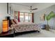 Comfortable bedroom features a ceiling fan, large windows, and decorative coral-themed accents at 1460 Gulf Blvd # 506, Clearwater Beach, FL 33767