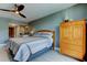 Bedroom featuring an armoire, a ceiling fan, and a view into a dressing area and bathroom at 1460 Gulf Blvd # 506, Clearwater Beach, FL 33767