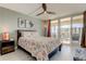 A bright bedroom opens to a balcony, complete with a ceiling fan and tasteful, modern decor at 1460 Gulf Blvd # 506, Clearwater Beach, FL 33767