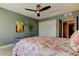Cozy bedroom features a ceiling fan, ample closet space, and a comfy bed with ocean-themed linens at 1460 Gulf Blvd # 506, Clearwater Beach, FL 33767