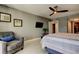 Bedroom with a mounted TV, an accent chair, and a doorway leading to an ensuite bathroom at 1460 Gulf Blvd # 506, Clearwater Beach, FL 33767