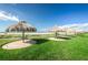 Well-maintained lawn featuring a row of charming tiki huts with stunning beach and ocean views at 1460 Gulf Blvd # 506, Clearwater Beach, FL 33767
