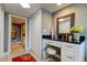 Dressing area with black countertops, white cabinets, a red rug, and access to a bathroom and closet at 1460 Gulf Blvd # 506, Clearwater Beach, FL 33767