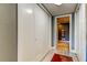 Hallway with closet doors, a red rug, and an entrance into an ensuite bathroom at 1460 Gulf Blvd # 506, Clearwater Beach, FL 33767