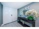 Hallway featuring modern console table with mirror and floral arrangement at 1460 Gulf Blvd # 506, Clearwater Beach, FL 33767