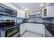Updated kitchen featuring white cabinets, stainless steel appliances, and tiled backsplash at 1460 Gulf Blvd # 506, Clearwater Beach, FL 33767