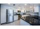 Bright kitchen featuring stainless steel appliances, white cabinetry and sleek countertops at 1460 Gulf Blvd # 506, Clearwater Beach, FL 33767