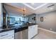 Open concept kitchen with bar seating and view of the living room at 1460 Gulf Blvd # 506, Clearwater Beach, FL 33767